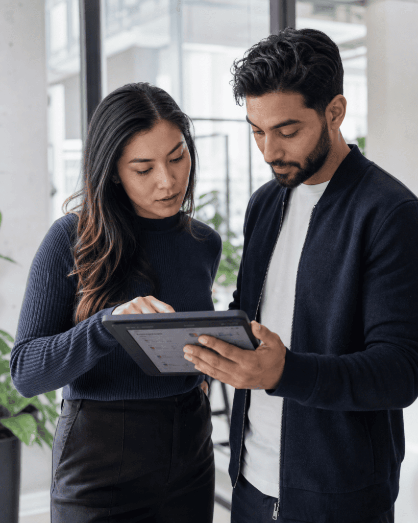 Younger fintech professionals reviewing Canadian MSB compliance requirements on a tablet